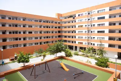 an apartment building with a playground in front of it at 3 bdr cozy apt in Condominio Mi, Palmarejo Grande in Praia