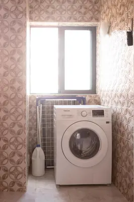 a washing machine in a bathroom with a window at 3 bdr cozy apt in Condominio Mi, Palmarejo Grande in Praia