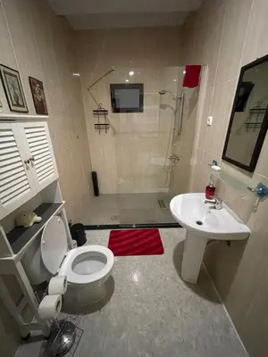 a bathroom with a shower and a toilet and a sink at Isa House - Private Rooms in a Shared Duplex in Praia