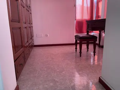 a room with a piano and a chair in it at Isa House - Private Rooms in a Shared Duplex in Praia