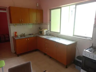 a small kitchen with a sink and a microwave at Casa Barreto in Tarrafal