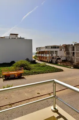 a bench in a parking lot next to buildings at BoaOp Apartments in Sal Rei