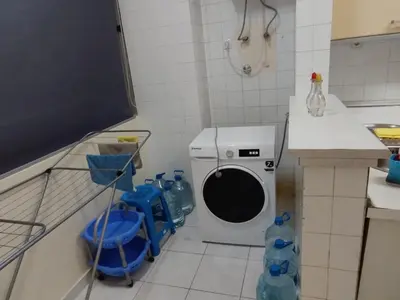 a kitchen with a washing machine in a room at Lalas ASA in Praia