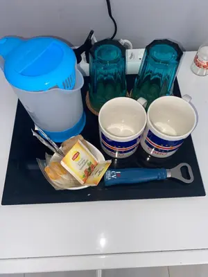 a shelf with bowls and other kitchen items on it at Katila-Rooms in Santa Maria