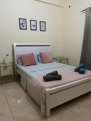 a bed with two pillows on it in a bedroom at Good Dreams Apartment in Praia