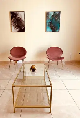 two chairs and a glass table in a room at Good Dreams Apartment in Praia