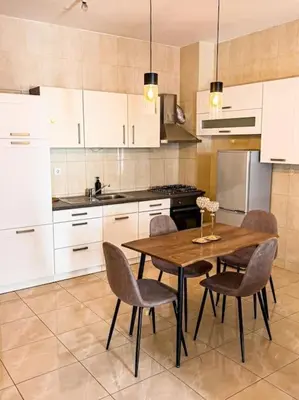 a kitchen with a wooden table and chairs at Good Dreams Apartment in Praia