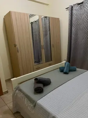 a bedroom with a bed and a large mirror at Good Dreams Apartment in Praia