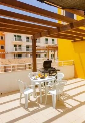 a patio with a table and chairs on a roof at Sol & Lar No stress in Santa Maria