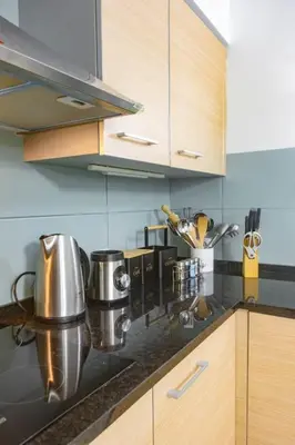 a kitchen with wooden cabinets and a counter top at Sol & Lar No stress in Santa Maria