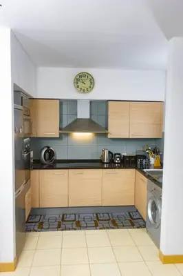a kitchen with a stove and a clock on the wall at Sol & Lar No stress in Santa Maria