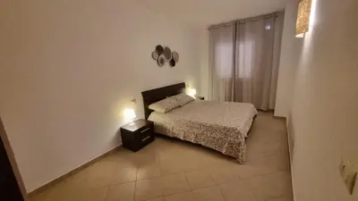 a small bedroom with a bed and two lights on at Isla de Sal in Santa Maria