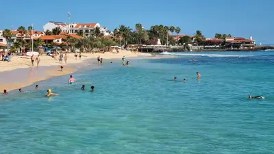 a group of people in the water at a beach at Isla de Sal in Santa Maria
