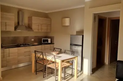a kitchen with a table and chairs and a refrigerator at Isla de Sal in Santa Maria