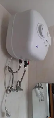 a bathroom with a toilet tank and a mirror at Apartamento Santos in Ribeira Grande