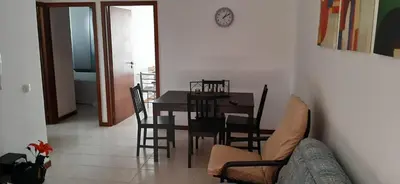 a kitchen and dining room with a table and chairs at Apartamento Santos in Ribeira Grande