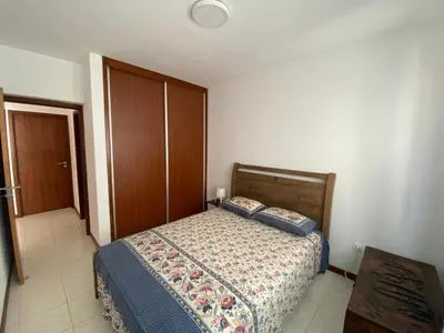 a bedroom with a bed and a wooden door at Apartamento Santos in Ribeira Grande