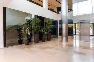 a hallway with potted plants in a building at Hotel Pérola in Praia