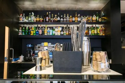 a bar with a counter with a lot of bottles at Hotel Pérola in Praia