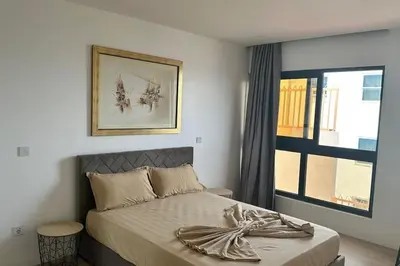 a bedroom with a bed and a window at Ocean Mirror Apartment in Praia