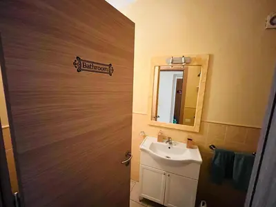 a bathroom with a sink and a mirror at Cozy Apartment with Pool, near Beach and Center in Santa Maria