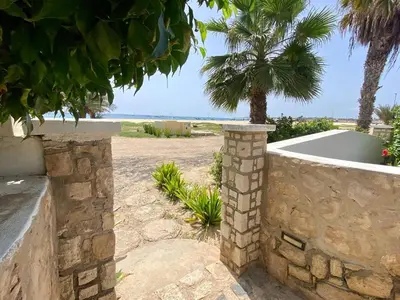 a stone retaining wall with a view of the ocean at Beach Villa - By Bobbywashere in Santa Maria