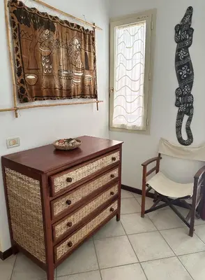 a room with a dresser and a chair and a window at KatlantiK Estoril Deluxe in Sal Rei