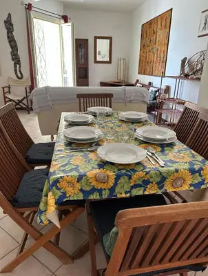 a dining room table with a floral table cloth on it at KatlantiK Estoril Deluxe in Sal Rei