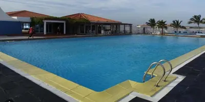 a large blue swimming pool in front of a building at Vila Paradise Sea & Swimming Pool View in Beirona