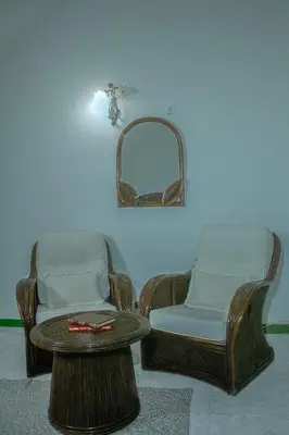 two chairs and a table in a room at Vila Paradise Sea & Swimming Pool View in Beirona