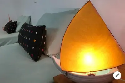 a bed with a pineapple shaped lamp on it at Vila na Mágica Baía da Murdeira in Beirona