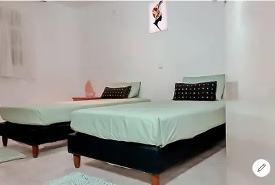 two beds sitting next to each other in a room at Vila na Mágica Baía da Murdeira in Beirona