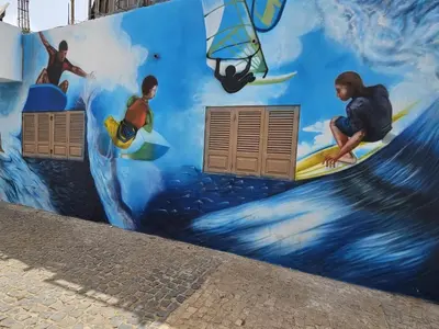 a mural of surfers on the side of a wall at Soleil Beach House in Santa Maria
