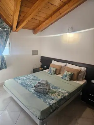 a large bed in a bedroom with a wooden ceiling at Soleil Beach House in Santa Maria