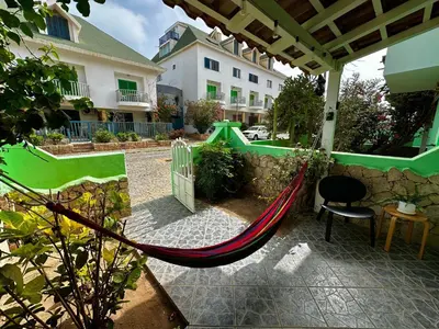 a hammock in a courtyard of a house at Wind Holiday Apartments - By Bobbywashere in Santa Maria
