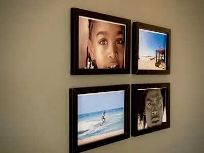 a group of four pictures hanging on a wall at Wind Holiday Apartments - By Bobbywashere in Santa Maria