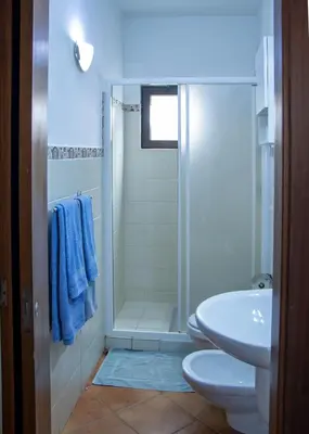 a bathroom with a shower and a toilet and a sink at Porto Antigo 2 - Apt 54 in Santa Maria