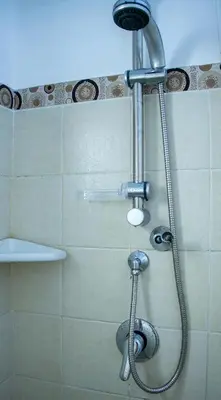a shower with a shower head in a bathroom at Porto Antigo 2 - Apt 54 in Santa Maria