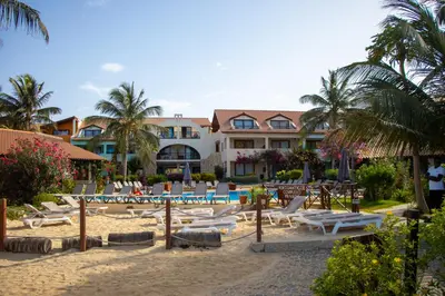 a resort with a bunch of lounge chairs on the beach at Porto Antigo 2 - Apt 54 in Santa Maria