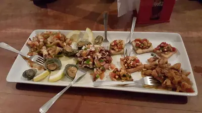 a plate of food on a table with forks and knives at Casa Café Mindelo in Mindelo