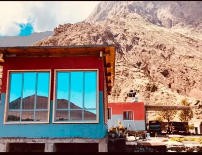 a building with windows in front of a mountain at Casa Adriano & Filomena Montrond in Portela