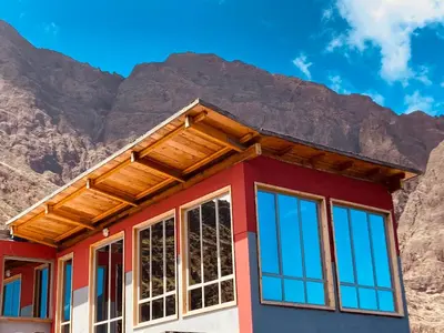 a house with mountains in the background at Casa Adriano & Filomena Montrond in Portela