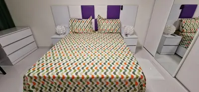 a bedroom with a bed in a room with mirrors at SUITES-HOME, CIDADELA in Praia