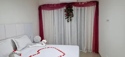 a bedroom with a bed with a heart on it at SUITES-HOME, CIDADELA in Praia