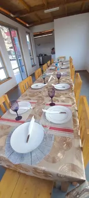 a large long table with white plates on it at Casa Adriano & Filomena in Portela