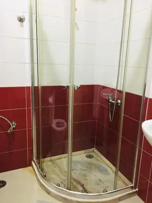 a shower with a glass door in a bathroom at Constança Retreat in Mindelo