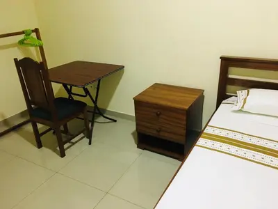 a bedroom with a bed and a desk and a chair at Constança Retreat in Mindelo
