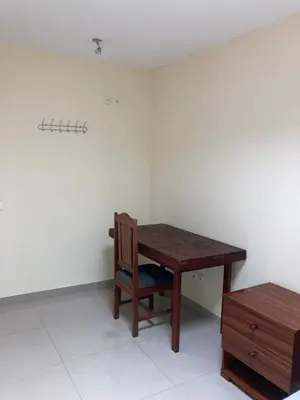 a room with a wooden table and a chair at Constança Retreat in Mindelo