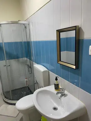 a bathroom with a sink and a toilet and a mirror at Constança Retreat in Mindelo