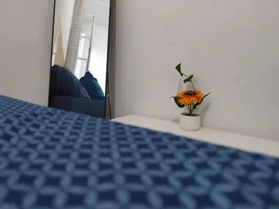 a room with a table with a vase of flowers at Mendes Family Homestay - B&B In The Heart Of Praia in Praia